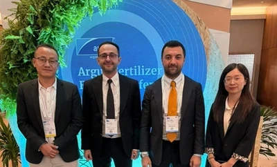 A group of four individuals standing in front of an event backdrop that features the Argus Fertilizer Europe Conference branding.