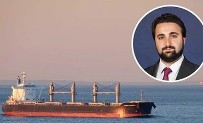 A cargo vessel sailing on calm water at sunset with a circular inset photo of an individual placed in the upper right corner.