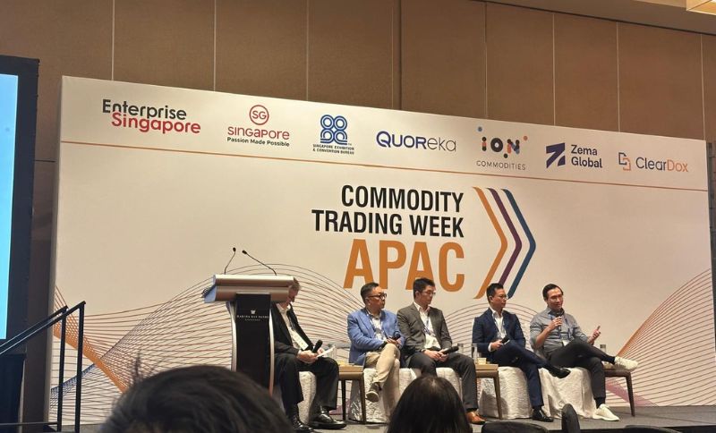 Panel discussion at a conference with several speakers seated on stage in front of a Commodity Trading Week APAC backdrop featuring sponsor logos.