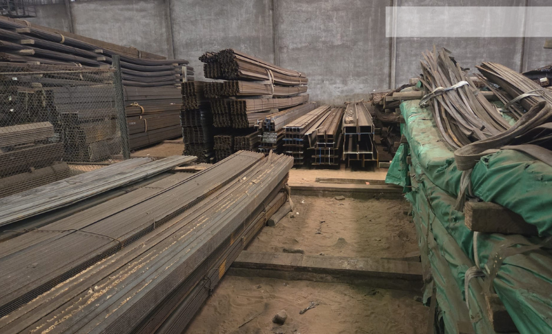 Stacked metal rods and industrial steel materials stored inside a manufacturing workshop during Alkagesta’s West Africa site visit.