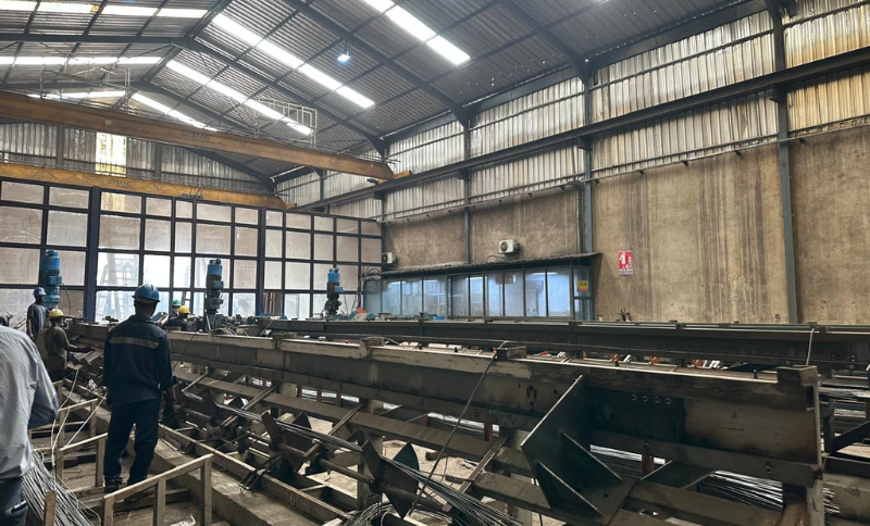 Industrial workshop with large steel structures and machinery observed during Alkagesta’s West Africa strategic site visit.