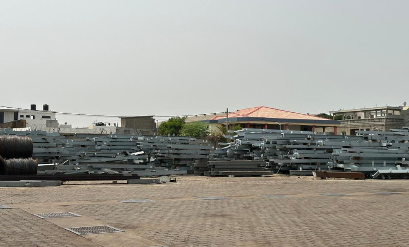 stacked steel structures and metal components stored in industrial yard at West Africa facility