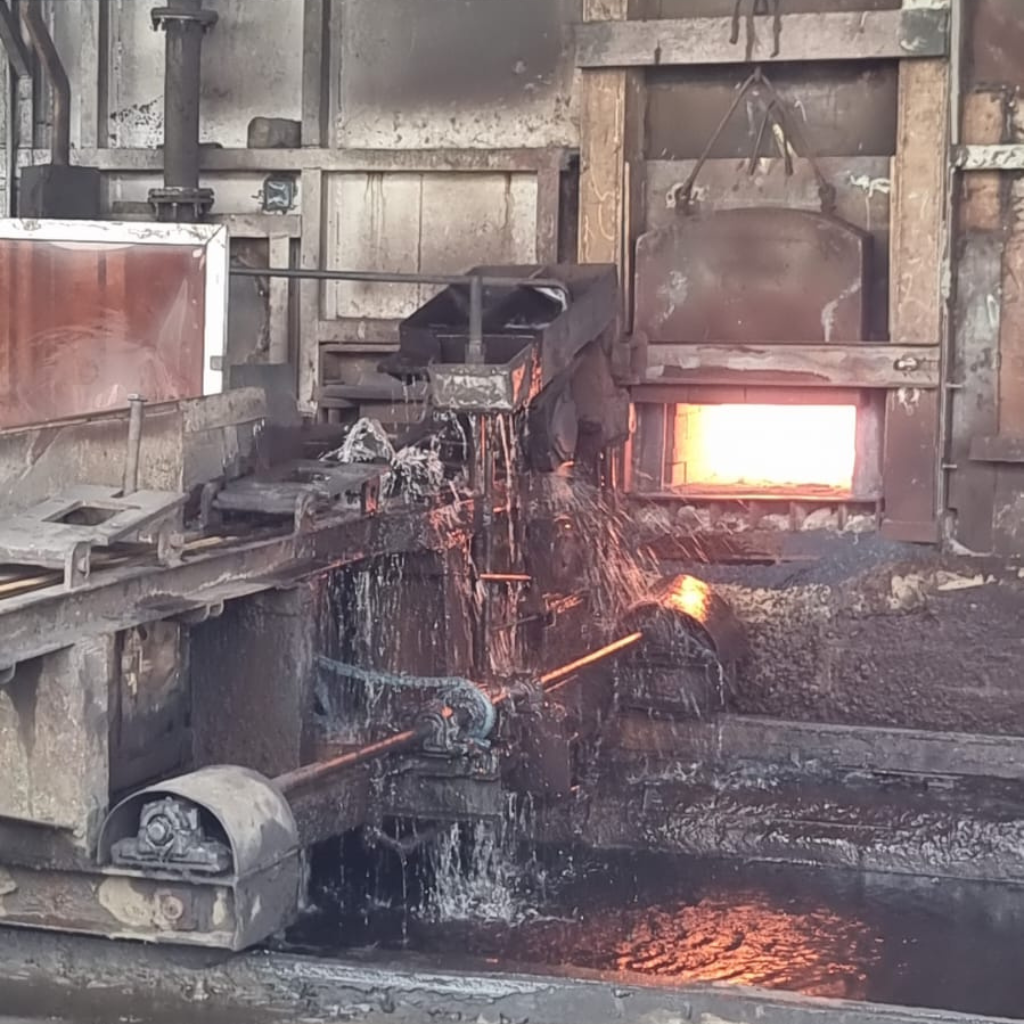 Active industrial furnace with molten metal processing and cooling water system inside a manufacturing facility during Alkagesta’s West Africa site visit.