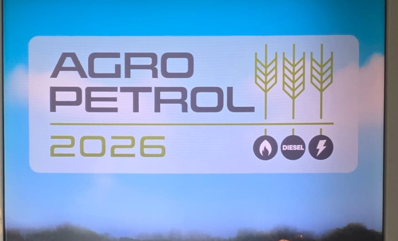 Event signage displaying the AgroPetrol 2026 conference logo with icons representing agriculture, diesel fuel, and energy, shown on a screen at the conference venue.