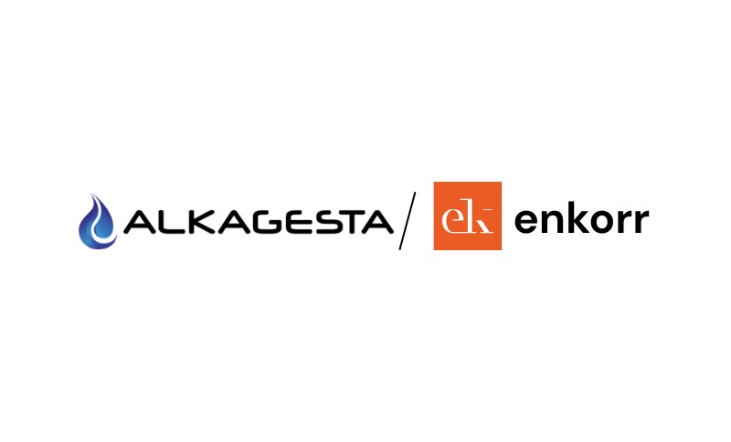 The Alkagesta logo displayed alongside the Enkorr logo on a white background, indicating a media feature or publication reference involving Alkagesta and Enkorr.