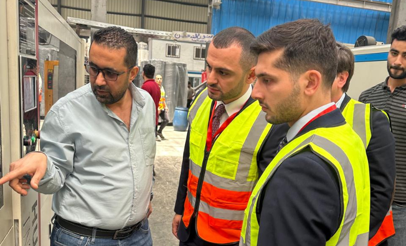 Alkavex delegation reviewing machinery controls during a steel factory inspection in Cairo.