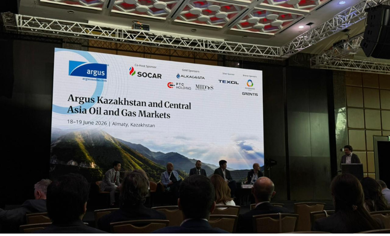 A conference panel sits on stage in front of a large screen displaying “Argus Kazakhstan and Central Asia Oil and Gas Markets, 18–19 June 2026, Almaty, Kazakhstan,” with event sponsors’ logos above.