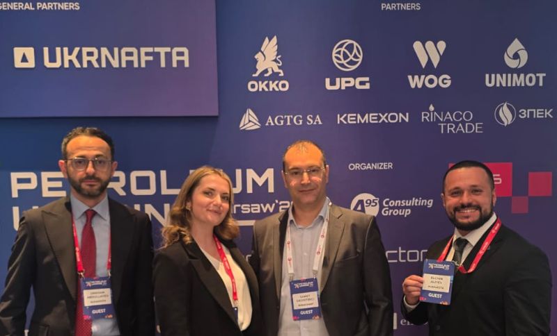 Alkagesta representatives at Petroleum Ukraine Warsaw 2026 conference in front of sponsor backdrop