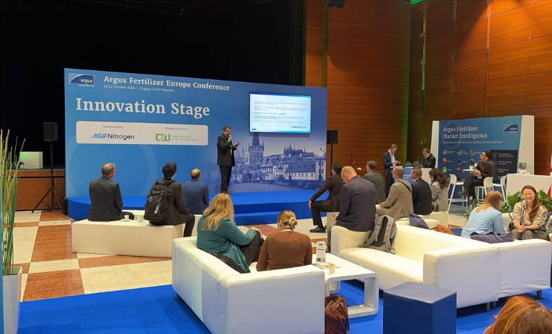 A speaker presents on the Innovation Stage at the Argus Fertiliser Europe Conference to an audience seated on lounge furniture.