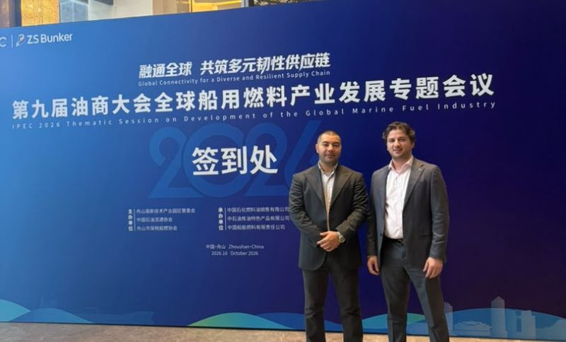 Two men in suits stand in front of a blue event backdrop for the IPEC 2026 Thematic Session on Development of the Global Marine Fuel Industry in Zhoushan, China.